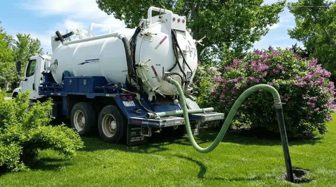 Professional vacuum truck performing residential drainage and septic maintenance in Cedar Rapids, IA
