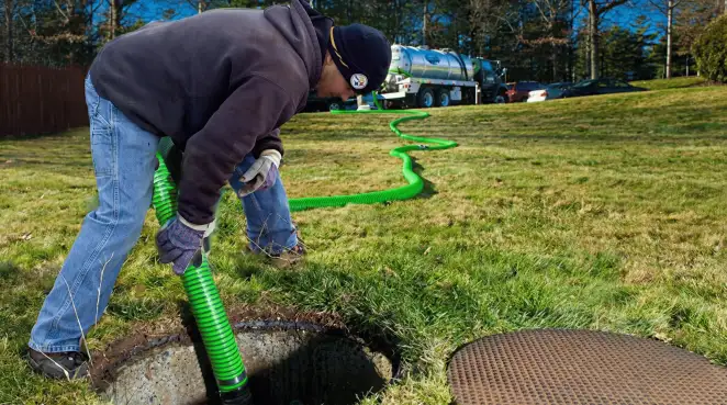 Service technician performing residential septic pumping and drainage maintenance in Cedar Rapids, IA